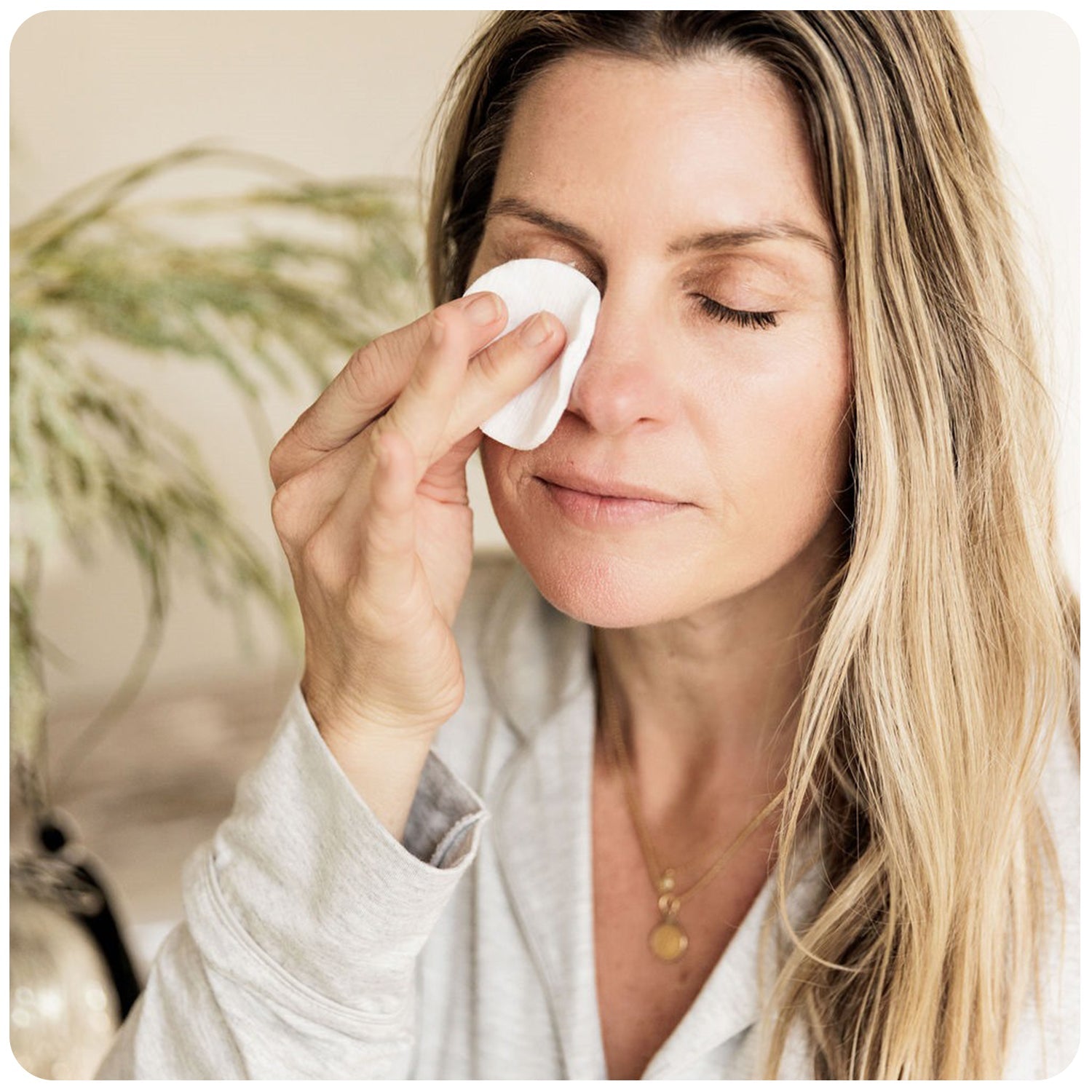 Woman cleansing her eyes.
