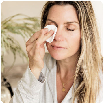 Woman cleansing her eyes.